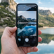 A photo of an iPhone in front of a beach